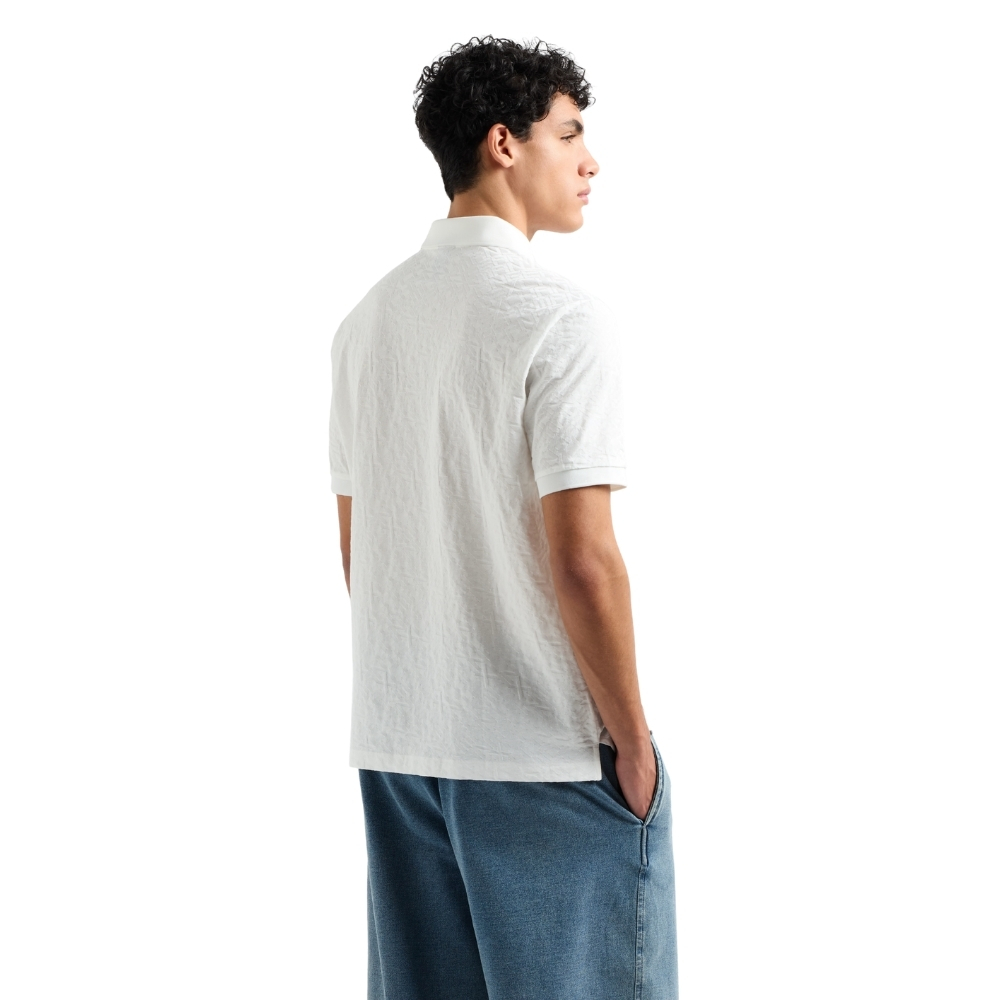 Polo Armani Exchange regular fit con logo all over torno su tono